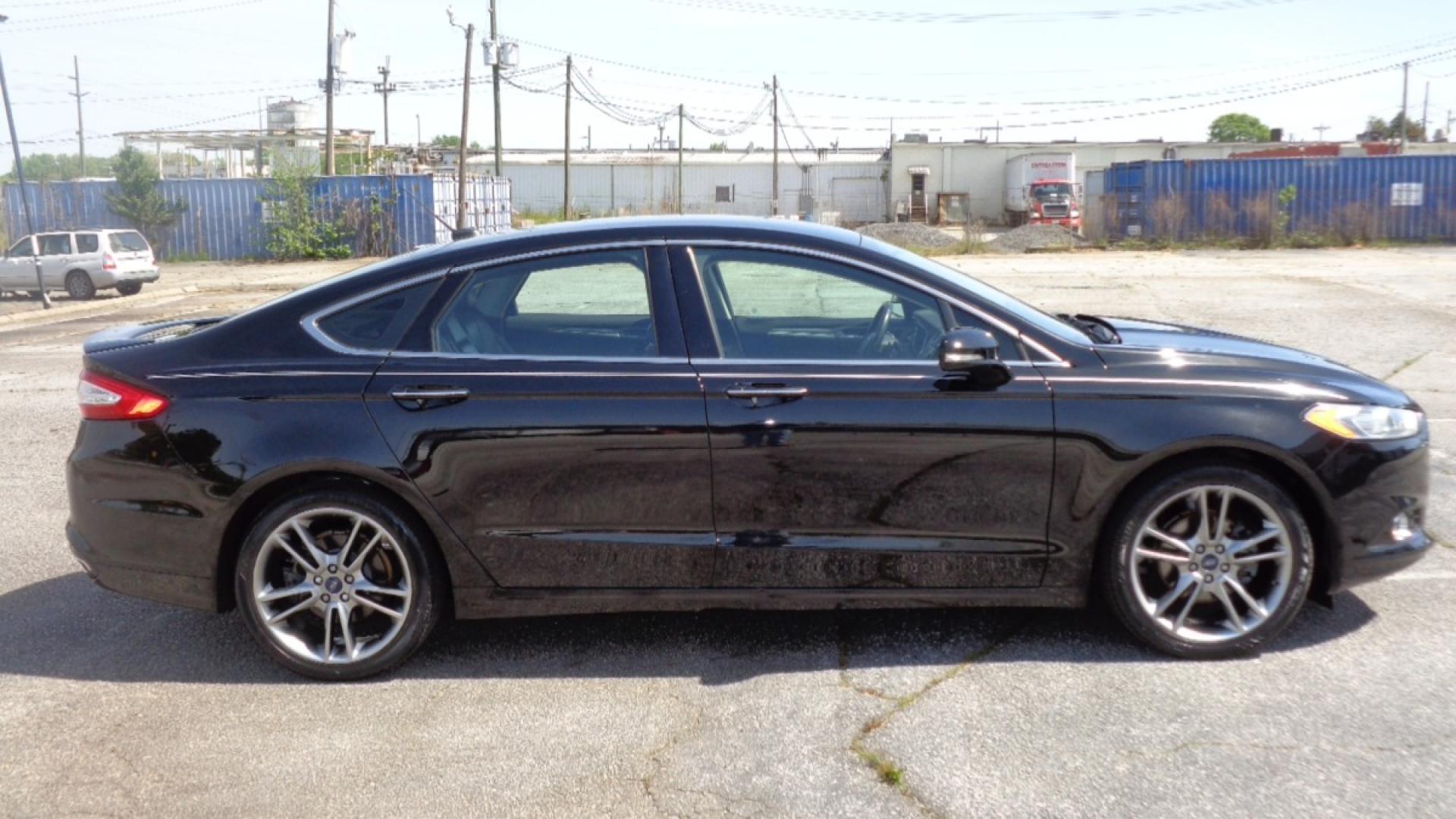 2016 BLACK /BLACK Ford Fusion Titanium (3FA6P0K99GR) with an 2.0L L4 DOHC 16V engine, 6-Speed Automatic transmission, located at 2812 White Horse Road, Greenville, SC, 29611, (864) 269-1711, 34.808655, -82.434776 - 3.6 LITER V6 ENGINE, 22 INCH BLACK RIMS W/ NEW SET OF TIRES,ANTI LOCK BRAKES,TILT/REACH STEERING,A/C,DUAL AIRBAGS,FRONT SIDE AIRBAGS,BODY COLOR BUMPERS,MIRRORS,AND DOOR HANDLES,CRUISE CONTROL, FOG LIGHTS ,AUTOMATIC HEADLIGHTS,USB/AUX OUTLET,VANITY MIRRORS,TRACTION COTNROL,POWER MIRRORS,WINDOWS,AND D - Photo#2